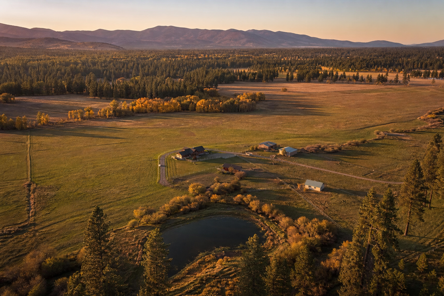 Ranch valley and pine forest below the Sierra foothills at golden hour