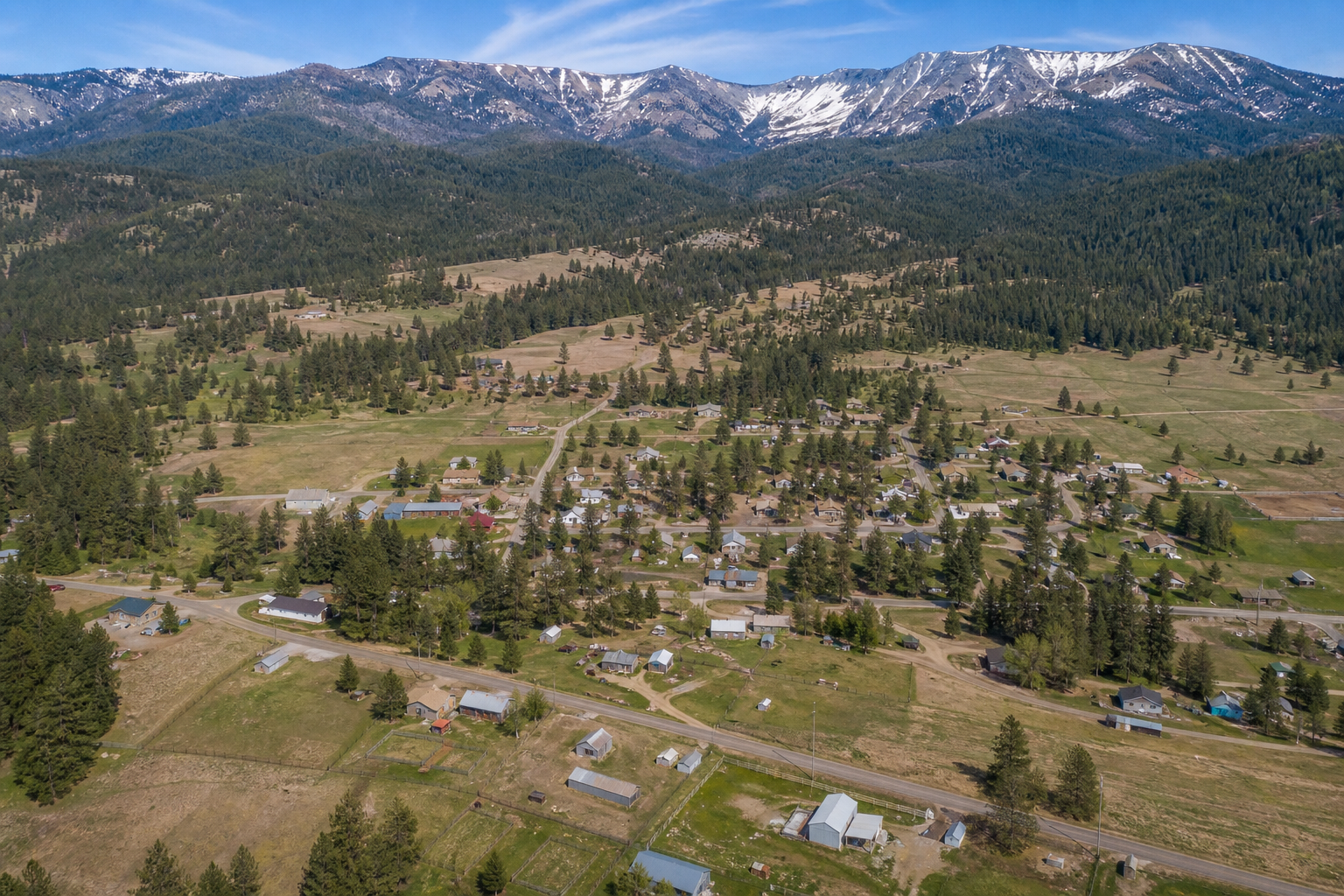 Aerial view of a small Northern California mountain town among pine forest